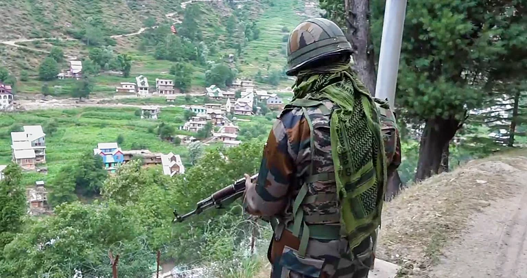 A security official stands guard amid heavy security near the site of a recent encounter with terrorists at Desa village, in Doda district, Wednesday, July 17, 2024 - PTI